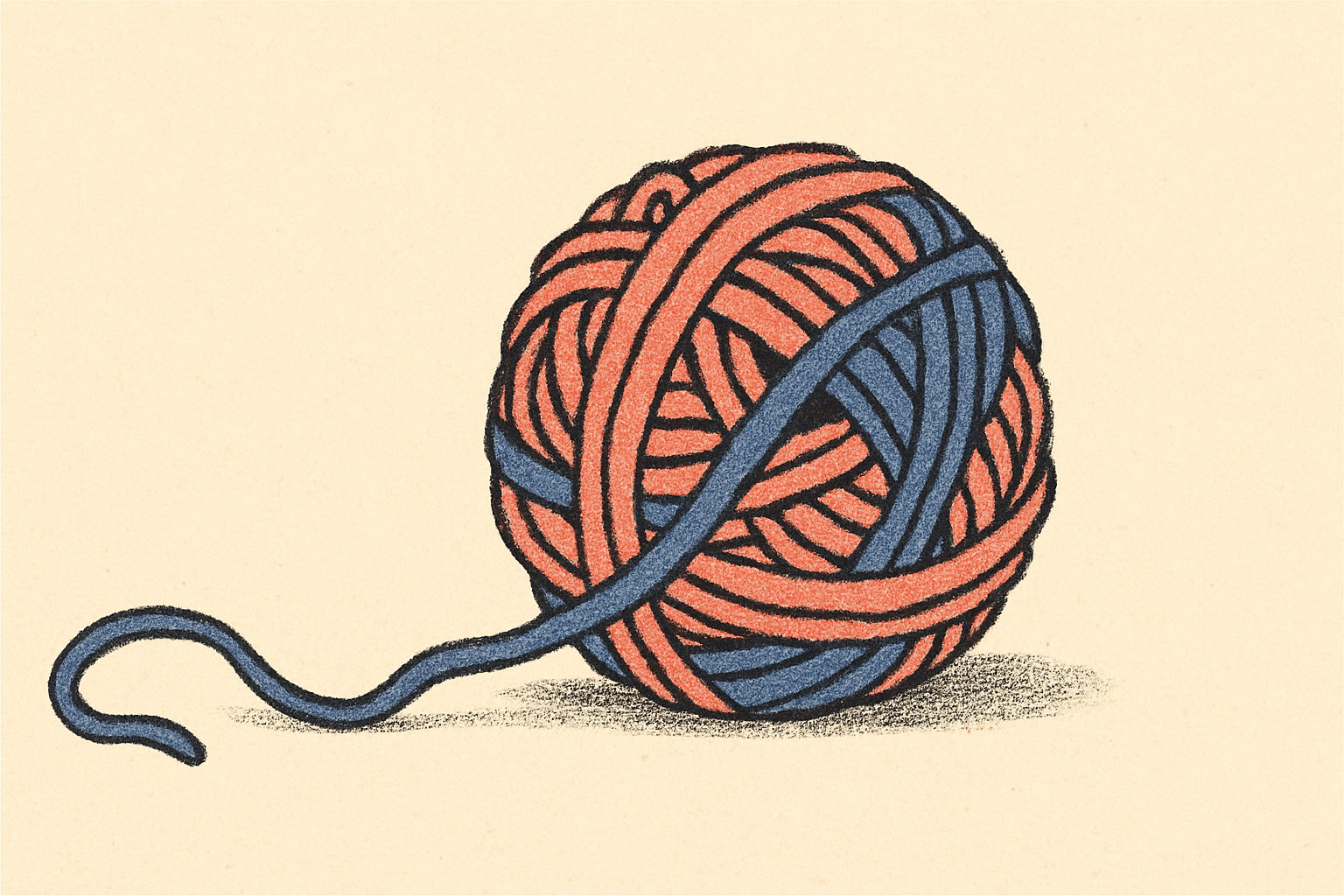 A tangled ball of coral and indigo yarn unraveling on a cream surface.